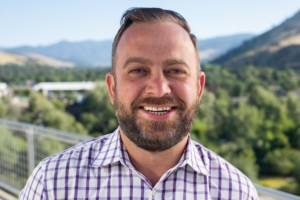 Garrett Cathcart headshot with mountains in the background