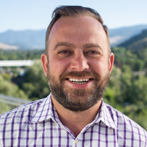 Garrett Cathcart headshot with mountains in the background