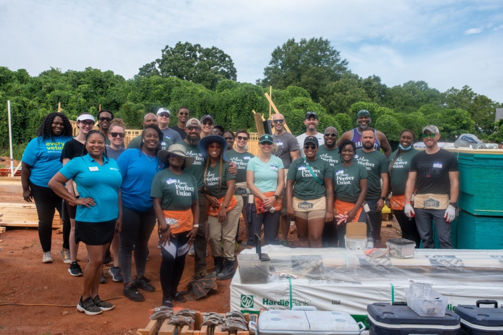 A group of 30 MPU members volunteering at a Habitat for Humanity home build