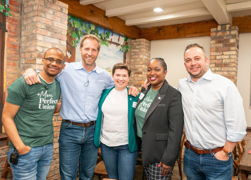 5 leaders of MPU, 1 Black man, 2 white men, 1 Black woman, and 1 nonbinary white person, take a photo together