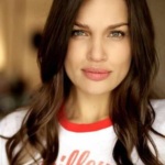 Headshot of a brown haired, white woman wearing a tshirt