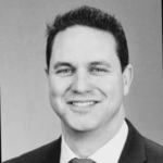 Black and white headshot of Sam LaNasa, a white man wearing a suit