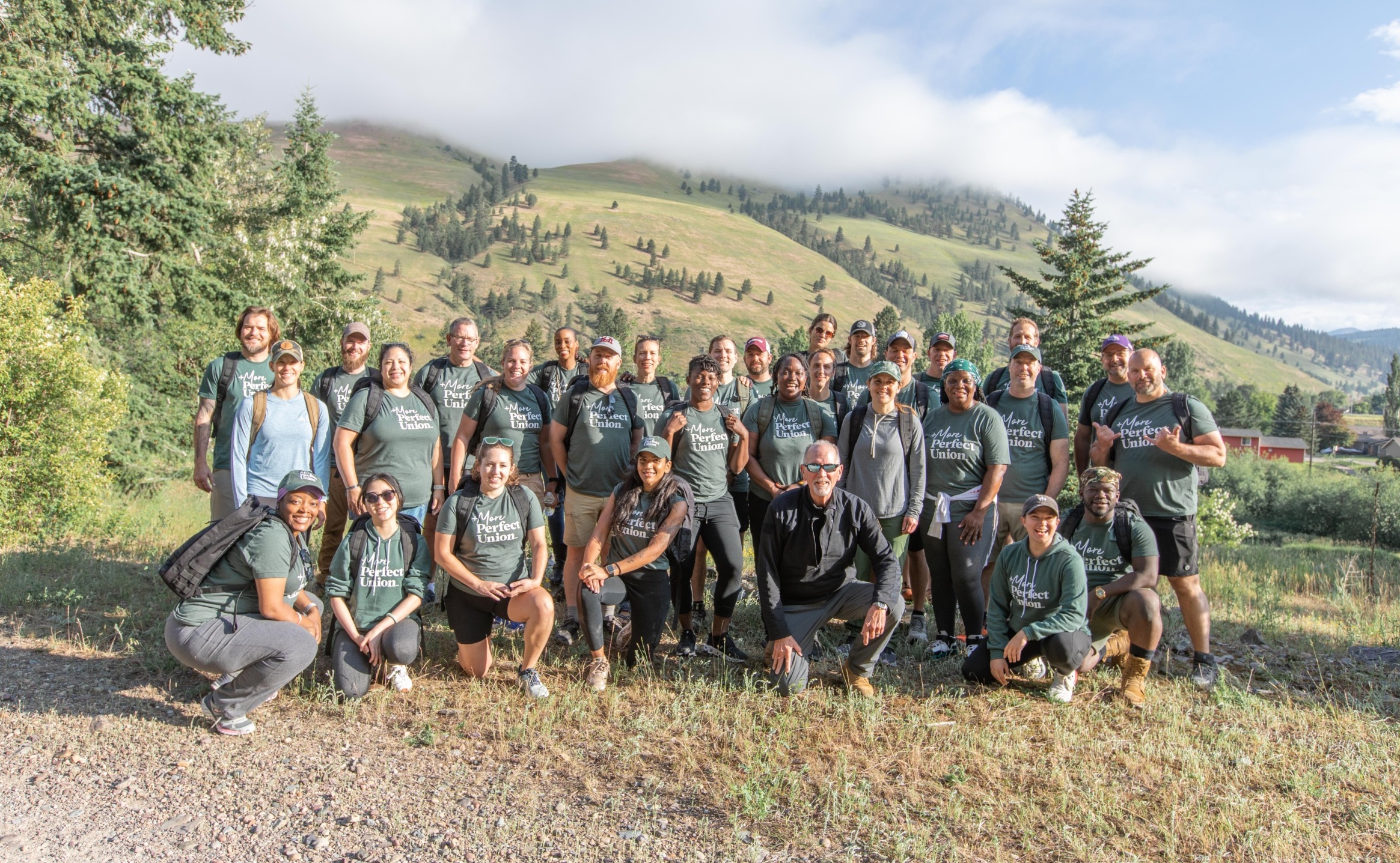 Group of 30 Americans of different backgrounds hiking in Montana wearing MPU tshirts.