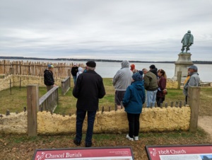 half a dozen white people walking around Jamestown settlement