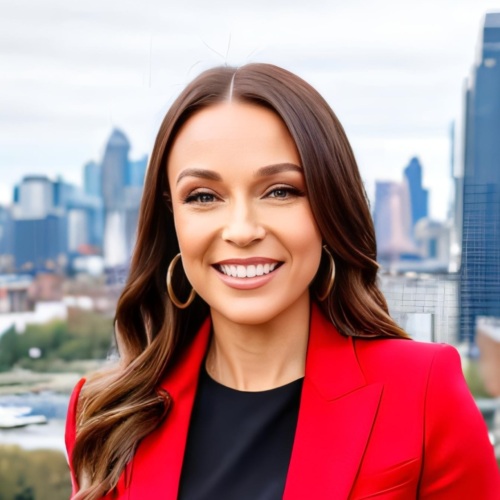 Headshot of Sarah Smith-Barry, a white woman with long brown hair wearing a red suit jacket.