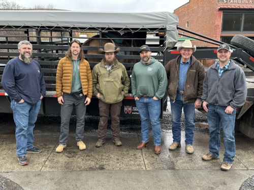 Image of six white men in Starbuck, Washington, dressed in jackets and work boots.